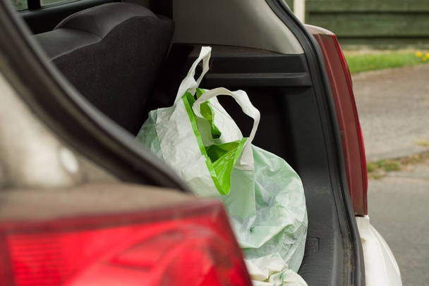 A closeup of a bag at the  in an open car trunk - Zdjęcie, obraz