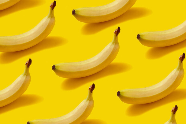 texture set of fresh ripe bananas on yellow background, close view - Фото, изображение