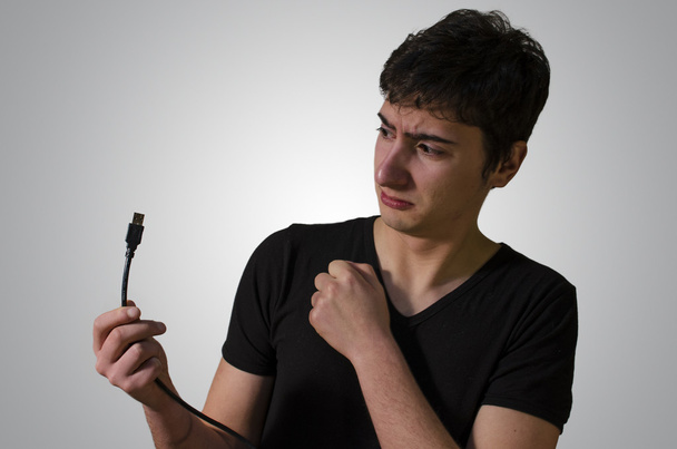 Young Man Arguing with a USB Cable - Photo, Image