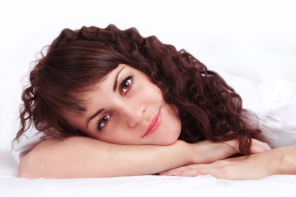 schöne junge Frau auf einem Bett liegend - Foto, Bild
