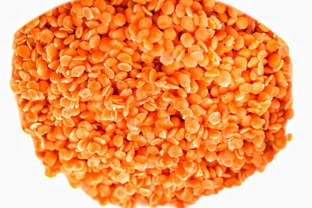 red lentils background.lentils isolated on white background.red lentils in a white bowl - Photo, Image