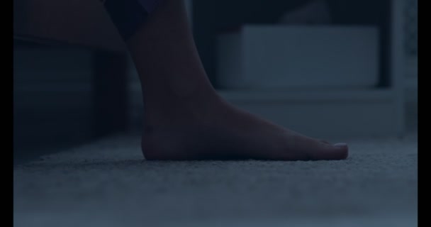 Feet of woman stepping out from bed and walking aside - Imágenes, Vídeo