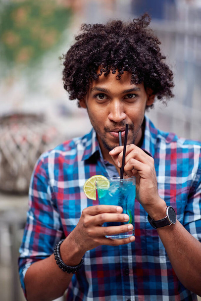 Photo portrait of young curly hispanic guy with cocktail - Foto, Imagen