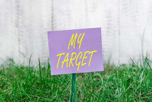 Writing note showing My Target. Business photo showcasing aiming for the goals desperately to achieve it successfully Plain paper attached to stick and placed in the grassy land. - Photo, Image