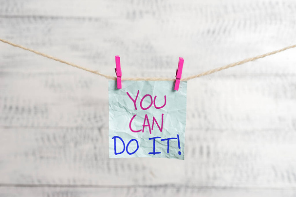 Writing note showing You Can Do It. Business photo showcasing can handle any tasks given despite challenges or problems Clothesline clothespin rectangle shaped paper reminder white wood desk. - Photo, Image