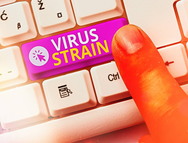 Conceptual hand writing showing Virus Strain. Business photo showcasing Another genetic variant derived from the original microorganism White pc keyboard with note paper above white key copy space. - Photo, Image