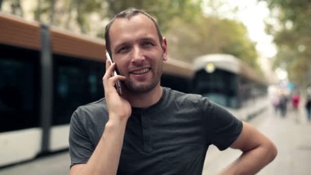 Man talking on cellphone in the city - Materiał filmowy, wideo
