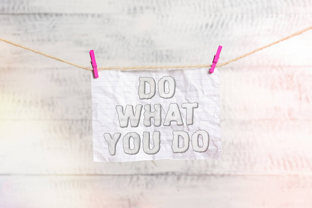 Handwriting text writing Do What You Do. Concept meaning can make things he wants to accomplish Achiever Doer Clothesline clothespin rectangle shaped paper reminder white wood desk. - Photo, Image