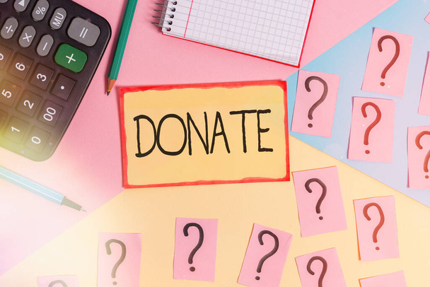 Text sign showing Donate. Conceptual photo gift for charity to benefit a cause may satisfy medical needs Mathematics stuff and writing equipment above pastel colours background. - Fotografie, Obrázek
