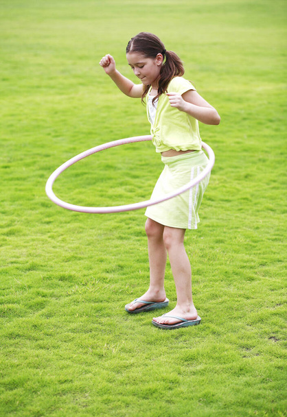 Girl playing the hoop ring - Foto, imagen