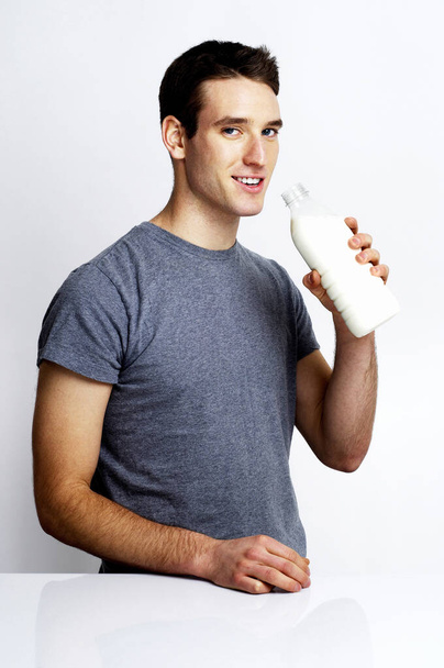 Man holding a bottle of milk - Photo, image