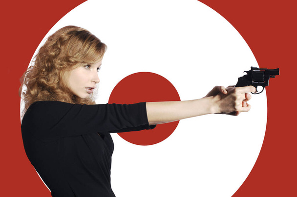 Businesswoman aiming a pistol - Foto, Imagen