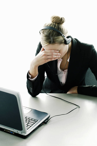 Businesswoman having headache in office - 写真・画像