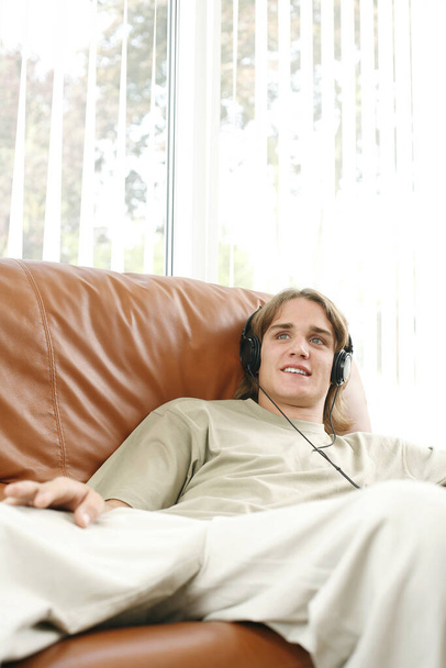 Young man listening to music - Fotó, kép