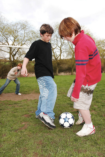 Boys playing football on the field - Fotografie, Obrázek