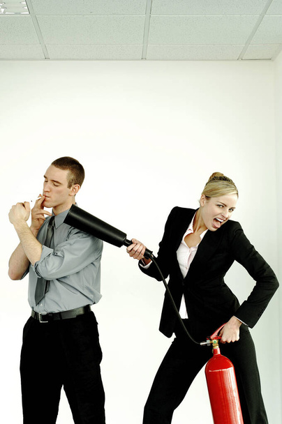 Businesswoman extinguishing her colleague for smoking in the office - Photo, Image