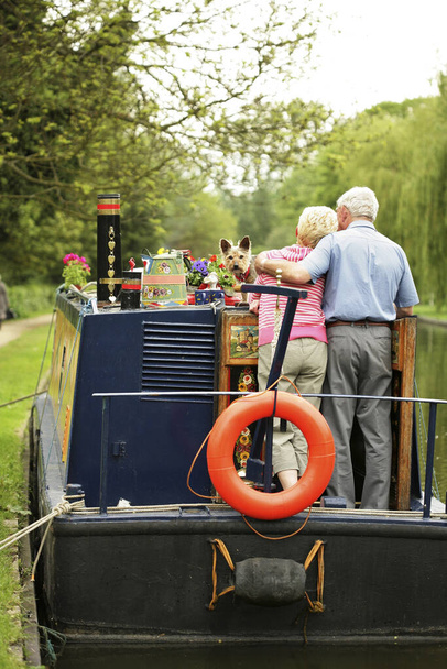 Senior couple and their dog on the houseboat - Photo, Image