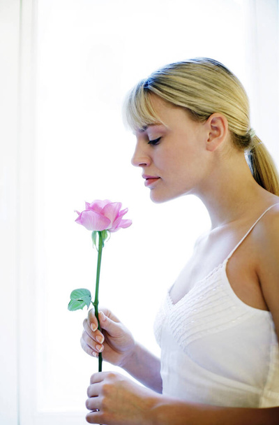 Woman smelling flower, close up view - Photo, image