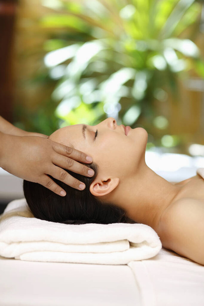 Woman enjoying a head massage - Foto, immagini