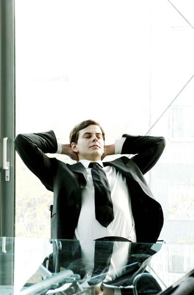 young businessman relaxing at office - Фото, изображение