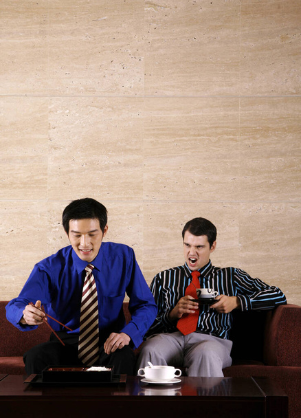 Businessmen enjoying a Japanese style lunch - Фото, зображення