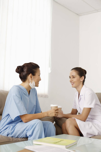 Nurses chatting during break time - Foto, afbeelding