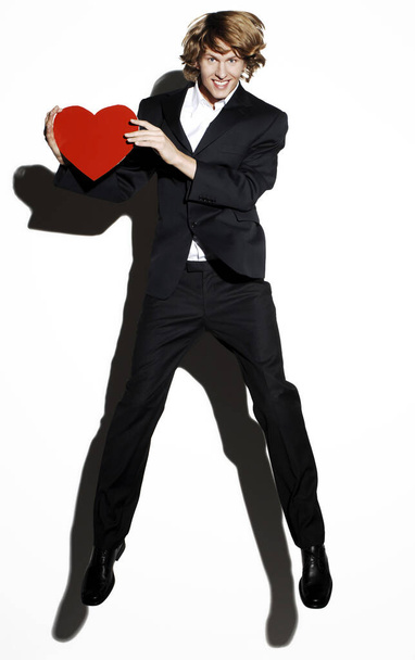 Businessman holding a red heart - Фото, зображення