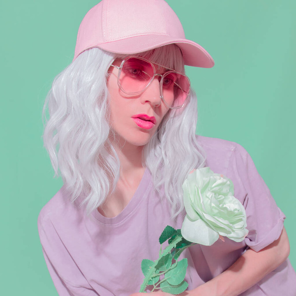 Fashion aesthetic girl with roses in trendy fresh summer accessories. Pink sunglasses and cap Vanilla Pastel colours design - Fotó, kép
