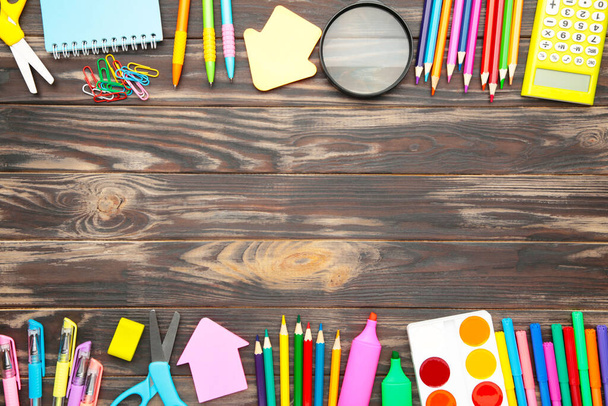 School supplies, stationery accessories on grey wooden background. Flat lay. - 写真・画像