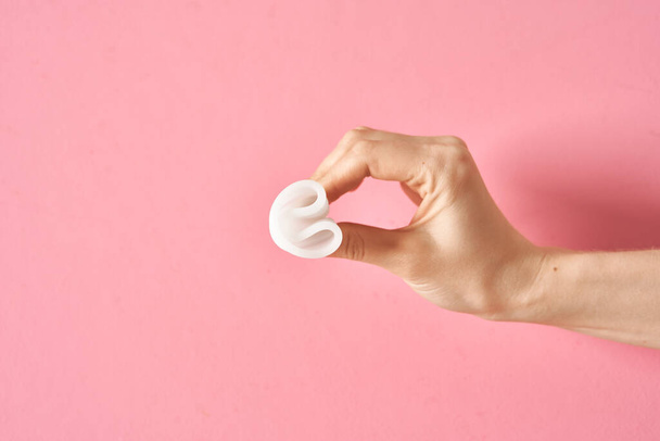 Menstrual cup eco friendly reusable and silicone in womans hand isolated on a white background - Photo, image