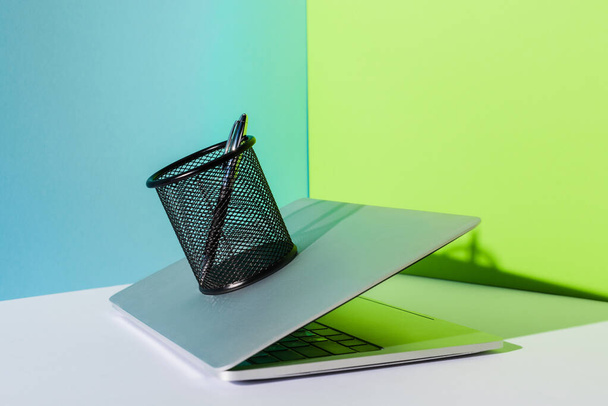 toll tartó modern laptop kék, fehér és zöld háttér - Fotó, kép