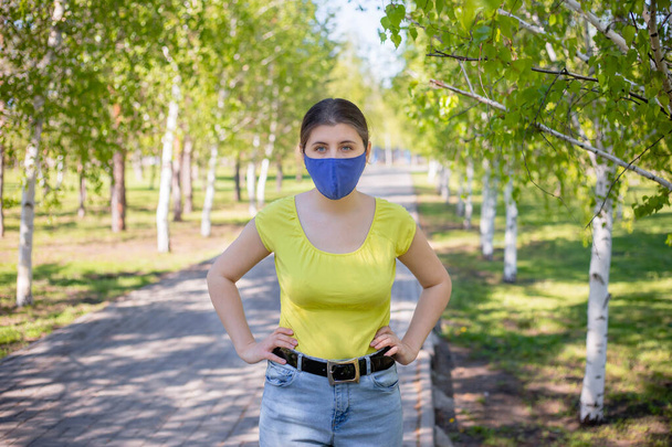 Portrait of a pensive woman in a blue mask on her face. - Foto, Imagem
