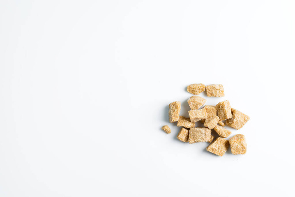Natural cane brown sugar cubes on a white background. - Photo, image