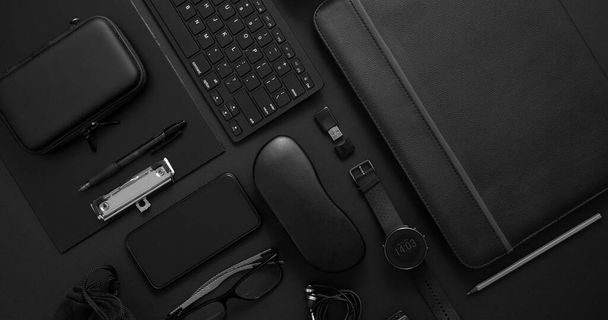 Business concept. Flat lay composition with various black gadgets on dark black surface - Photo, image