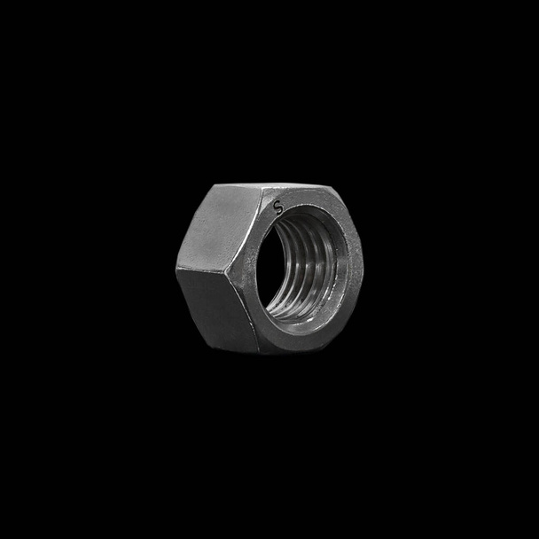 Steel nut on a black background. Isolate - Photo, Image