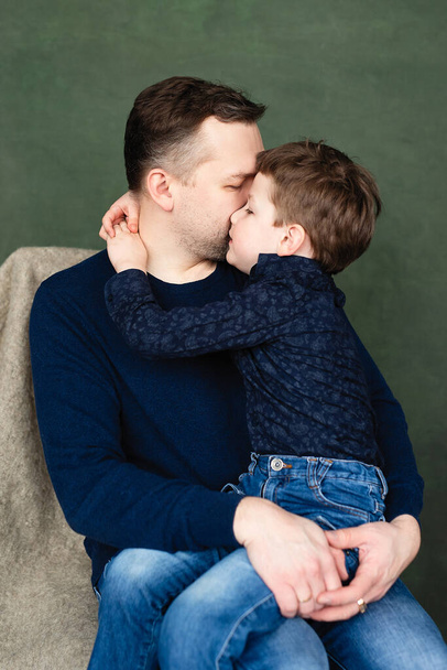 boy hugs and kisses his dad, man holds child in his arms - Foto, immagini