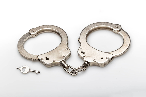 handcuffs isolated over white background  - Φωτογραφία, εικόνα