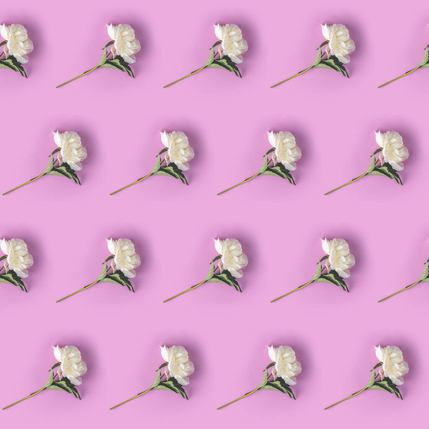 Creative layout made with white peony flowers on pink background. Flat lay. Flower composition - Photo, image
