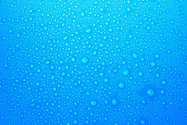 closeup drops water on blue background - Valokuva, kuva