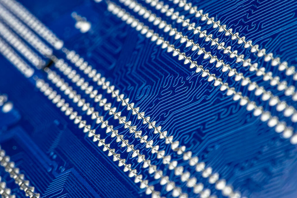 Macro photo of electrical paths on blue circuit board, visible s - Foto, Bild