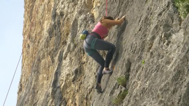 CLOSE UP: Young woman goes rock climbing up a mountain in Slovenian countryside. - Footage, Video