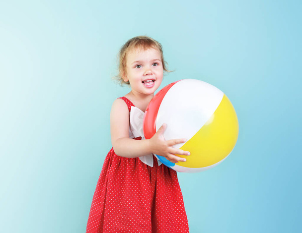 Caucasian child girl portrait with beach ball in hands,kid with toy summer design. - Photo, image
