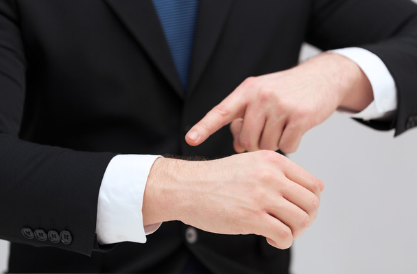 Businessman pointing to something at his hand - Photo, Image