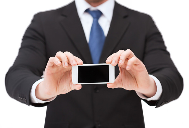 Businessman showing smartphone with blank screen - Фото, зображення