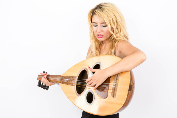 young beautiful blonde lady playing oud - Photo, Image