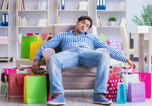 Young man after excessive shopping at home - Photo, Image