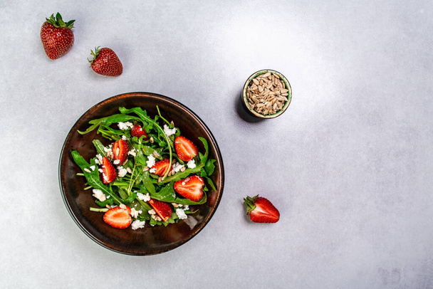 Strawberry salad with arugula and cheese. Healthy food. banner menu recipe place for text, top view. - Fotoğraf, Görsel
