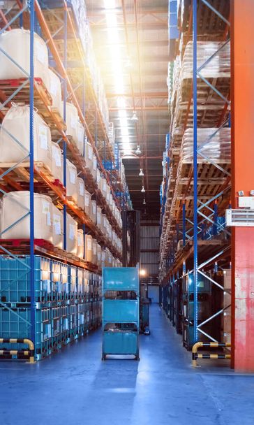 Large distribution warehouse interior, pallets and boxes of cargo stack on row of high shelves. - Photo, Image