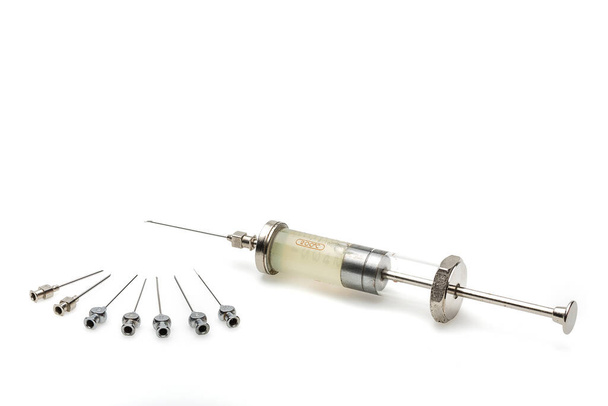 big metal syringe with needles on a white background - Foto, imagen
