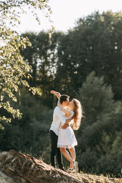 A happy young couple about to kiss. Couple walks in nature at sunset. - Foto, immagini